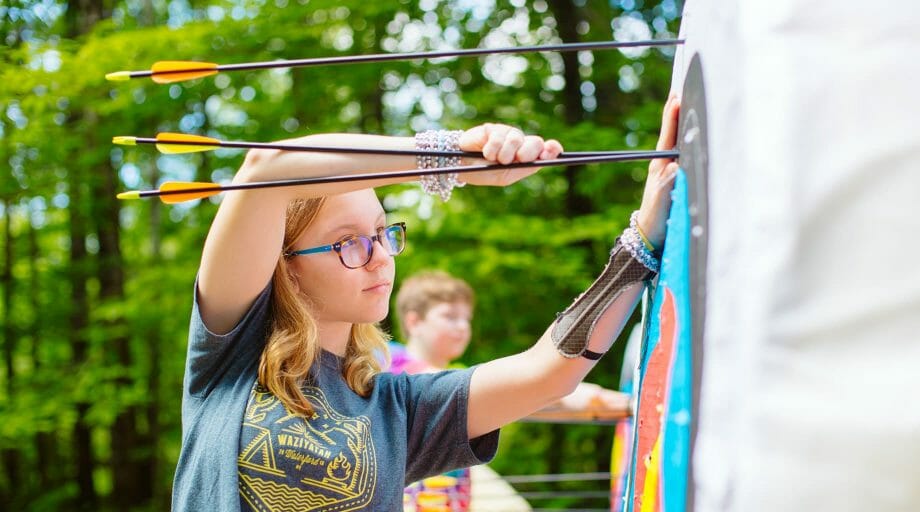 Girl shooting archery arrow