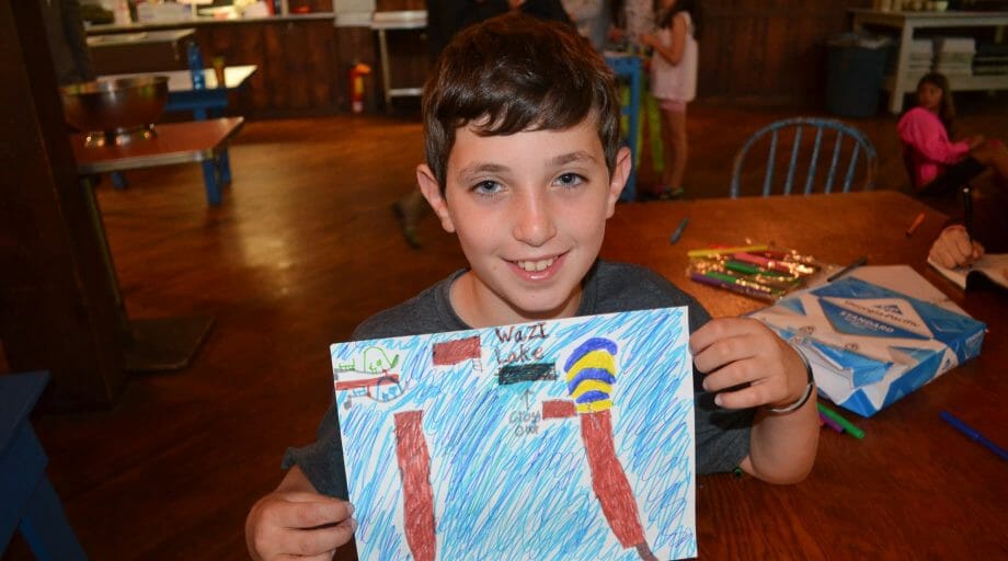 Boy showing his drawing