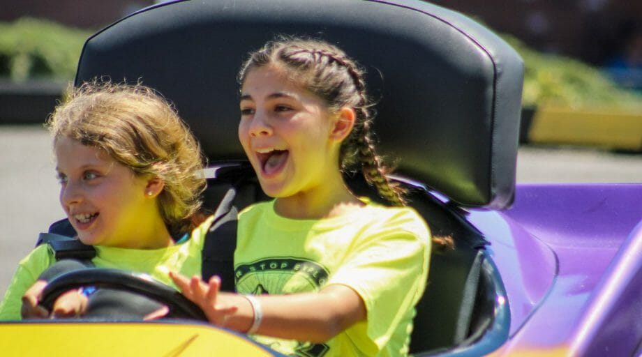 Two girls go karting on an off-camp trip