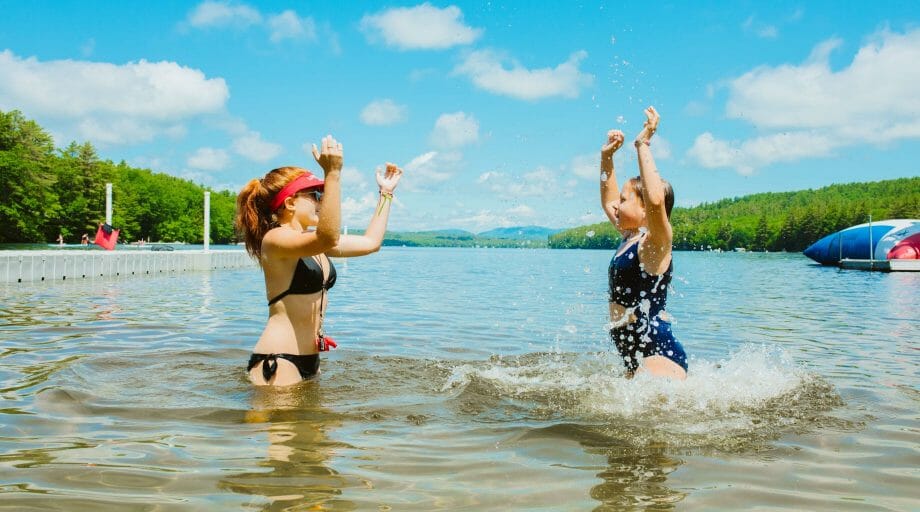 Staff teaching camper how to swim