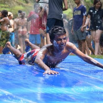 Camper covered in shaving cream on the slip n slide