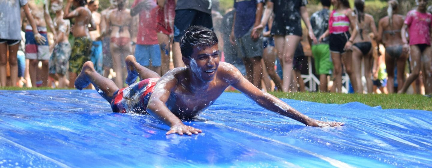 Camper covered in shaving cream on the slip n slide