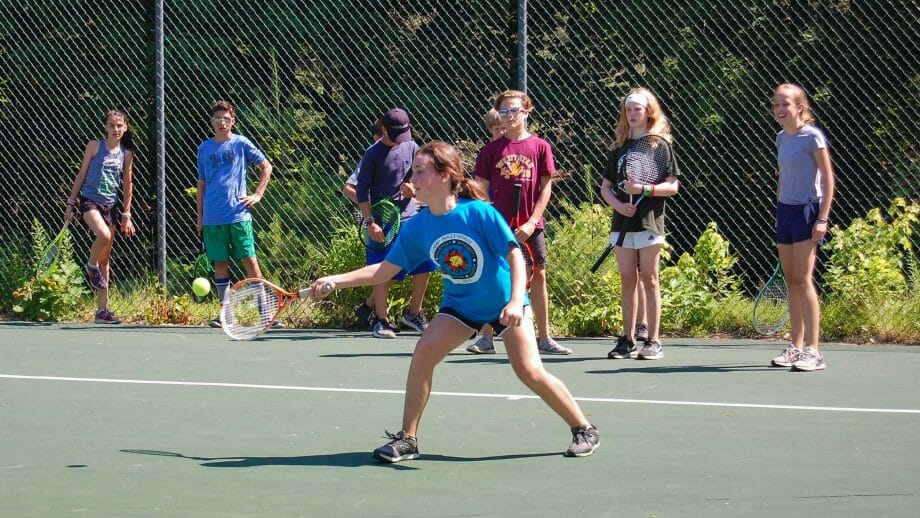 Camper hitting a tennis ball