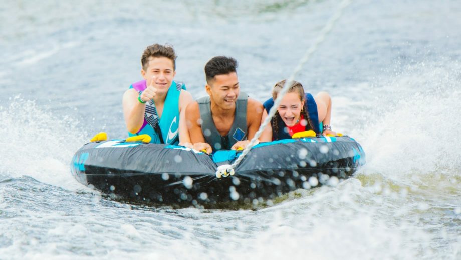 Campers watertubing on the lake