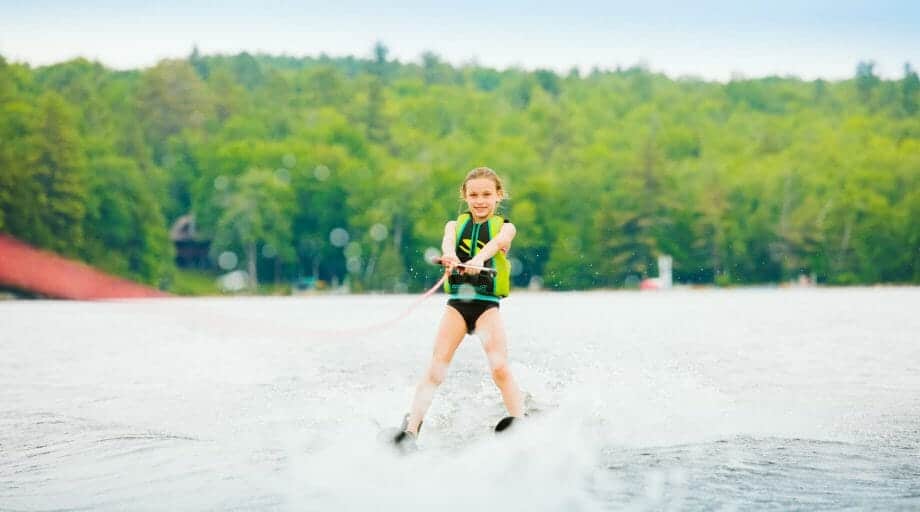 Young girl waterskiing on the lake