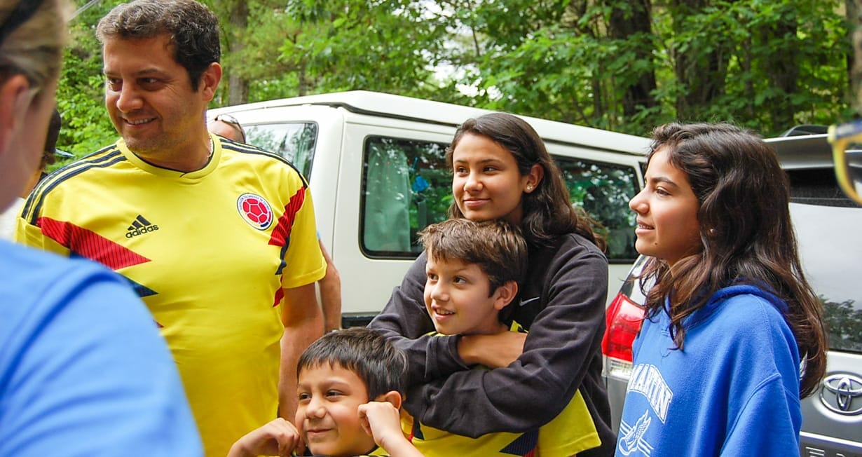 Parent and campers hugging on arrival day to camp