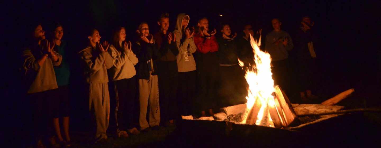 Singing around a campfire