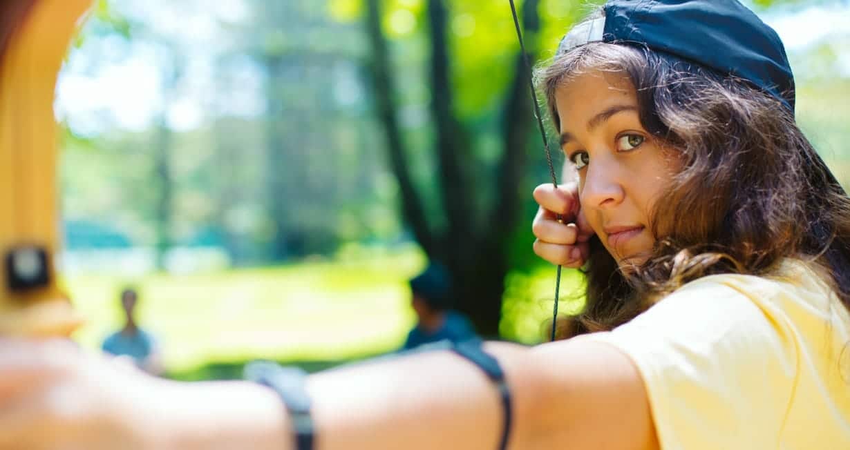 Girl shooting archery arrow
