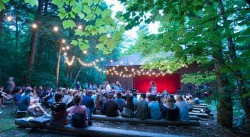 Campers attending an event at the outdoor theater