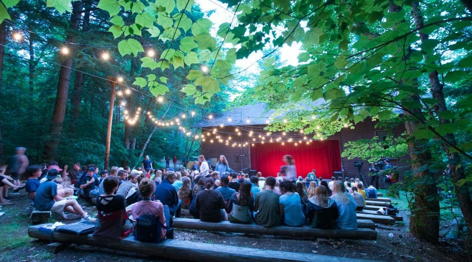 Campers attending an event at the outdoor theater