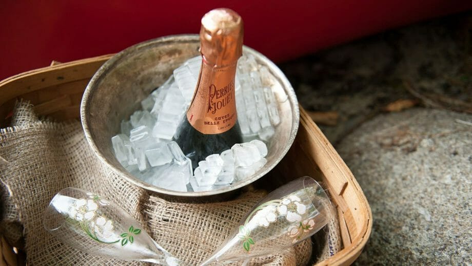 Champagne in a bucket with ice at a wedding