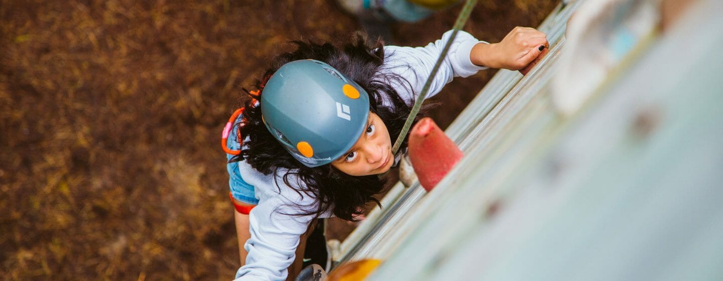 Girl climbing the rock tower